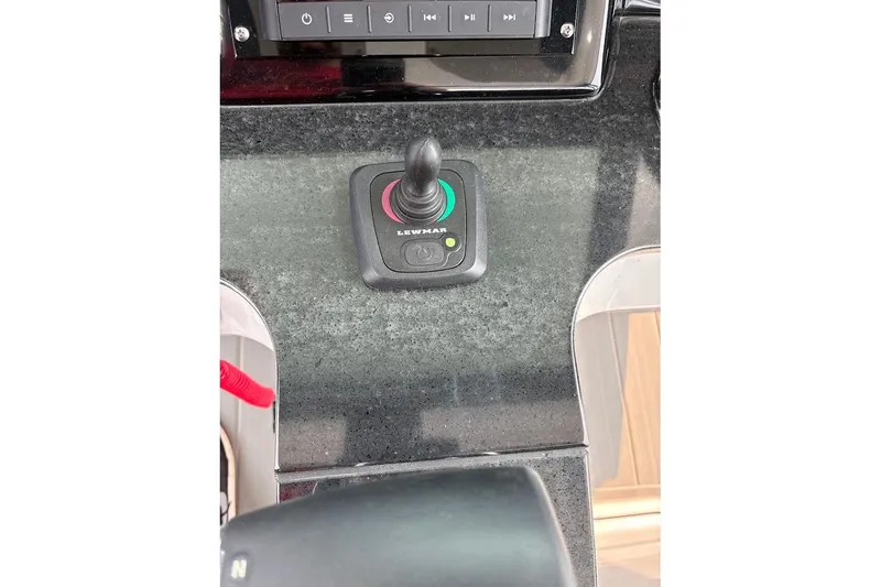 Slide: The Image of Control panel of 2026 Monterey Elite 25 OB boat with joystick and buttons. - 5