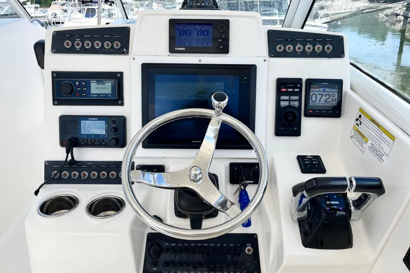 Slide: The Image of Control panel of a 2014 Edgewater 280CX Crossover boat with navigation and communication systems. - 25
