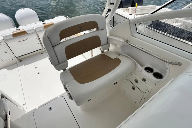 Slide: The Image of 2014 Edgewater 280CX Crossover boat interior with cushioned seating and cup holders. - 20