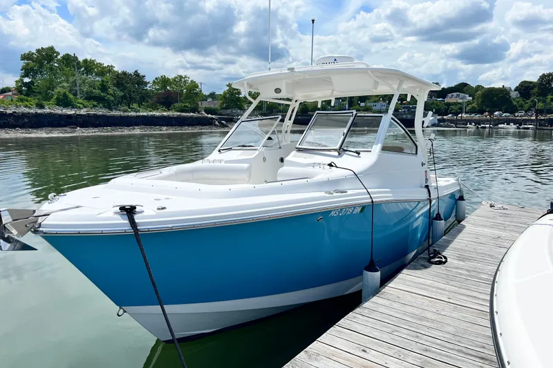 Slide: The Image of 2014 Edgewater 280CX Crossover boat docked on a sunny day. - 4