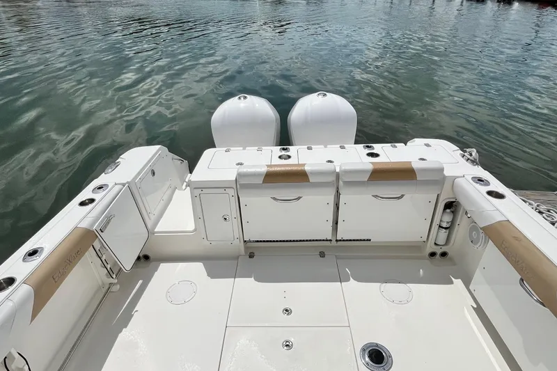 Slide: The Image of 2014 Edgewater 280CX Crossover boat deck with dual engines on calm water. - 18