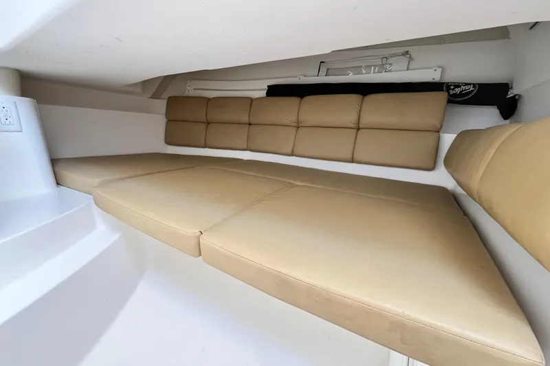 Slide: The Image of 2014 Edgewater 280CX Crossover cabin interior with beige cushioned seating. - 30