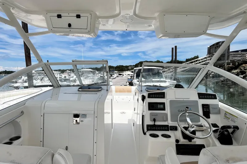 Slide: The Image of Interior view of 2014 Edgewater 280CX Crossover boat, featuring helm and dashboard controls. - 26