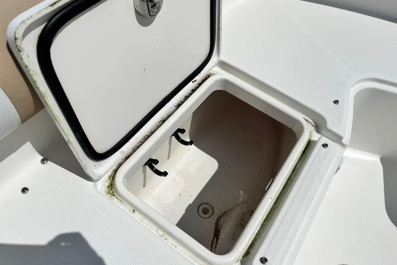 Slide: The Image of Open storage compartment on 2014 Edgewater 280CX Crossover boat, showing interior details. - 34