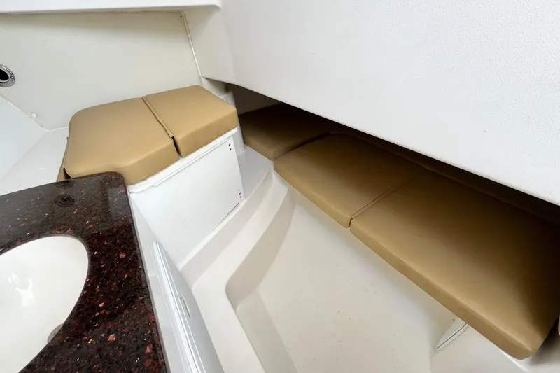 Slide: The Image of Interior cabin of 2014 Edgewater 280CX Crossover with beige seating and countertop. - 29