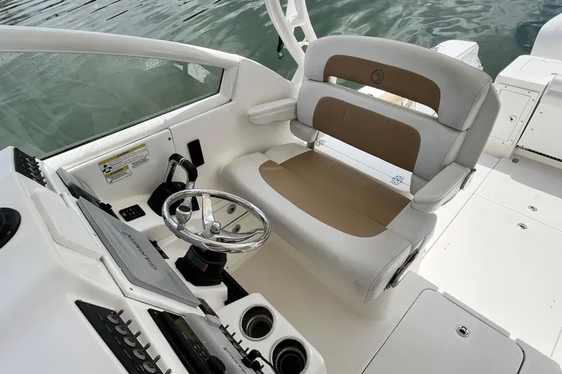 Slide: The Image of 2014 Edgewater 280CX Crossover boat interior with steering wheel and seating. - 22