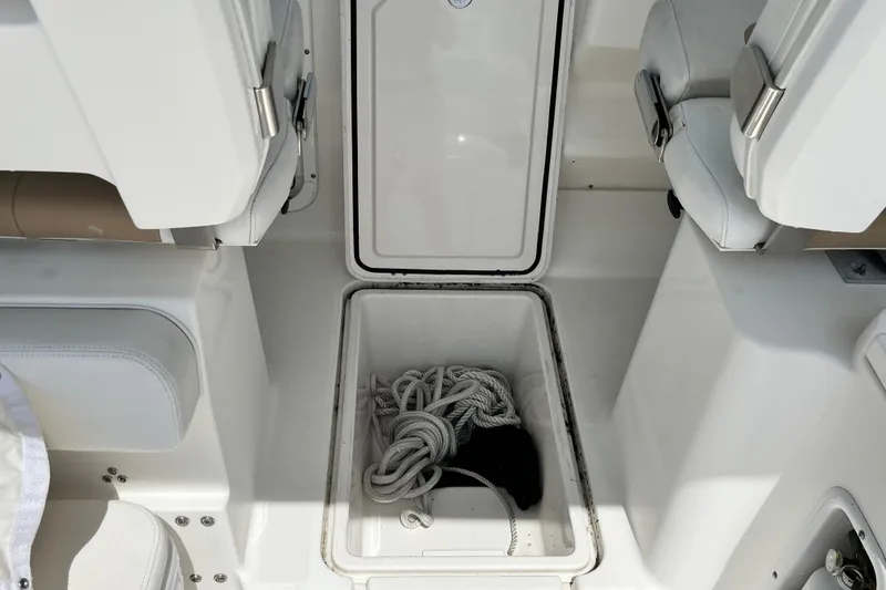Slide: The Image of Storage compartment with rope on a 2014 Edgewater 280CX Crossover boat. - 33