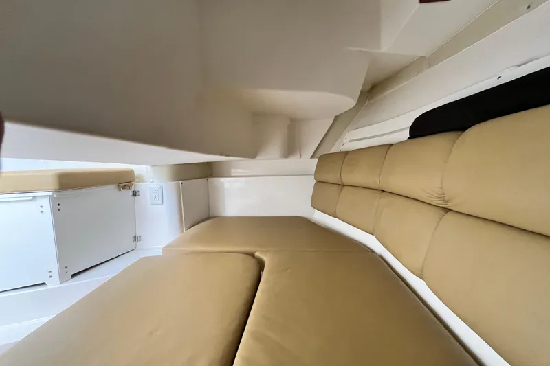 Slide: The Image of Interior cabin of 2014 Edgewater 280CX Crossover with beige cushions and white cabinetry. - 31