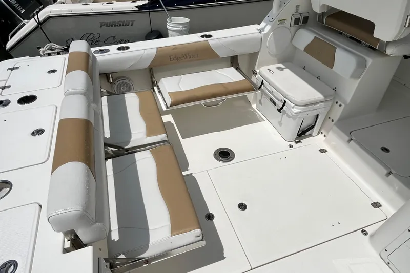 Slide: The Image of 2014 Edgewater 280CX Crossover boat interior with seating and storage compartments. - 14