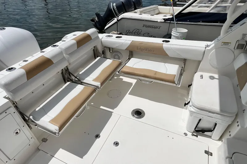 Slide: The Image of 2014 Edgewater 280CX Crossover boat interior with seating and Yamaha engines. - 13