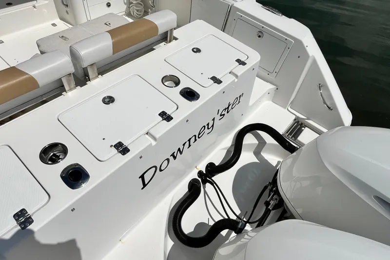 Slide: The Image of 2014 Edgewater 280CX Crossover boat deck with seating and storage compartments. - 10