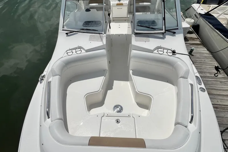 Slide: The Image of 2014 Edgewater 280CX Crossover boat with spacious seating, docked at a marina. - 28