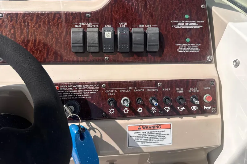 Slide: The Image of Control panel of a 2009 Sea Ray 270 Sundancer boat with various switches and warnings. - 16