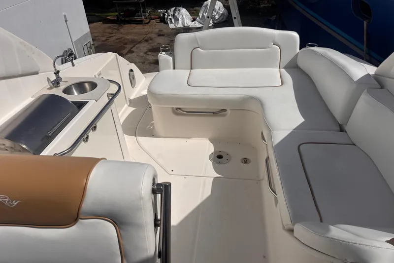 Slide: The Image of 2009 Sea Ray 270 Sundancer boat interior with white seating and kitchenette area. - 18