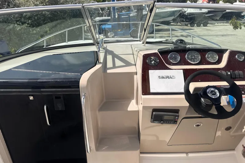 Slide: The Image of 2009 Sea Ray 270 Sundancer helm with steering wheel and instrument panel. - 17