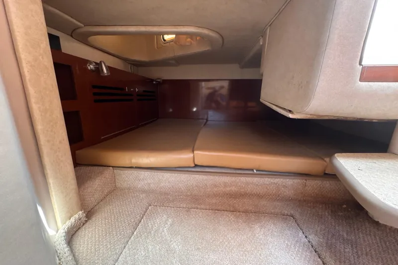 Slide: The Image of Interior cabin of 2009 Sea Ray 270 Sundancer with beige cushions and carpet. - 23