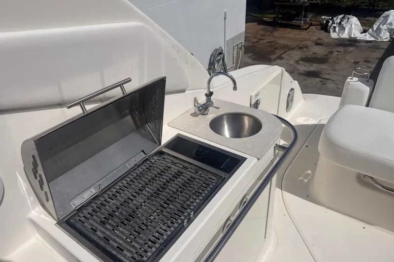Slide: The Image of Outdoor kitchenette on 2009 Sea Ray 270 Sundancer with grill and sink. - 13