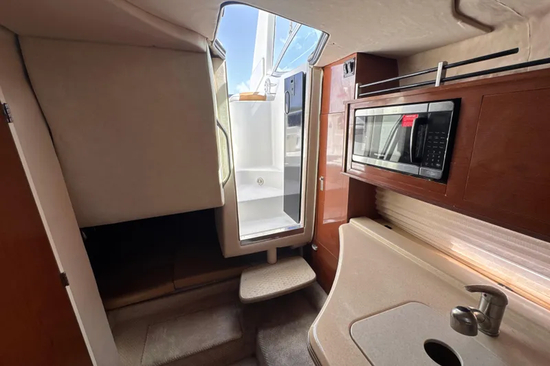 Slide: The Image of Interior of 2009 Sea Ray 270 Sundancer with kitchenette and microwave. - 25