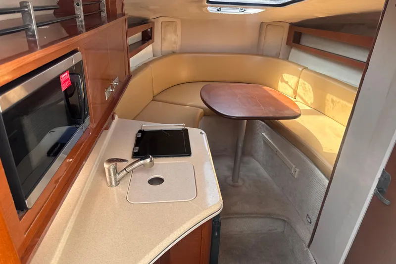 Slide: The Image of 2009 Sea Ray 270 Sundancer cabin interior with kitchenette and seating area. - 19