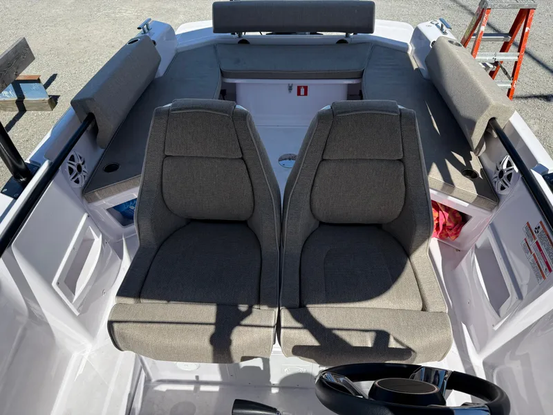 Slide: The Image of The image shows the interior of a 2024 Axopar 22 T-Top boat with two cushioned seats. - 5