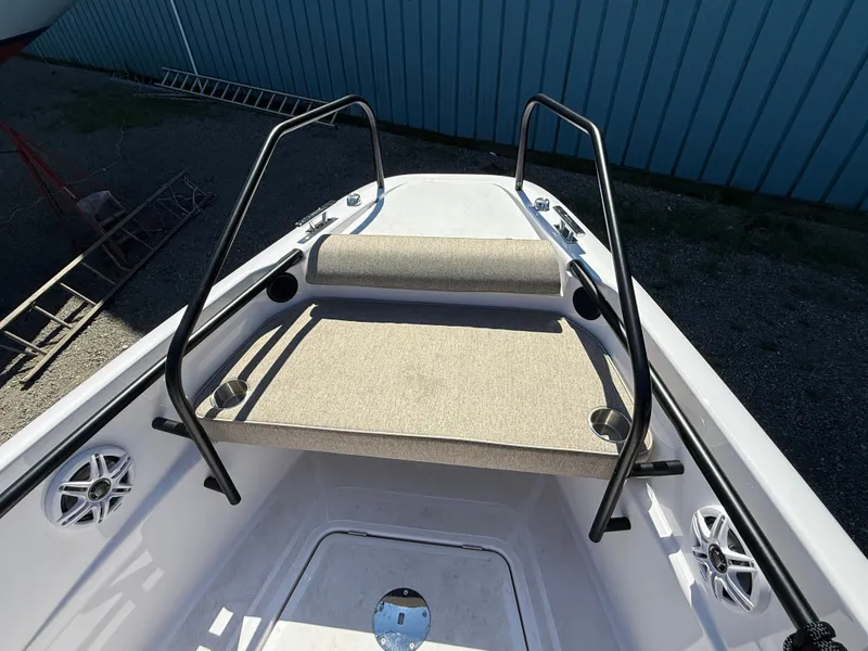 Slide: The Image of The image shows the bow of an Axopar 22 T-Top boat with a bench seat and cup holders. - 9