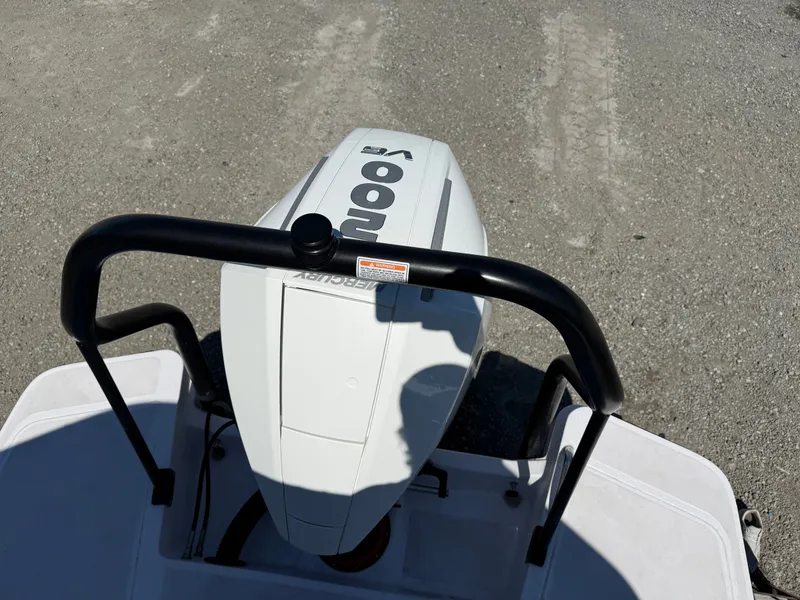 Slide: The Image of A Mercury outboard motor is mounted on a boat, surrounded by a protective railing. - 16