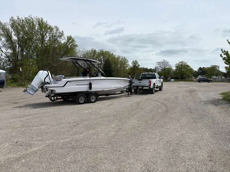 Slide: The Image of A 2024 Axopar 22 T-Top boat is being towed on a trailer by a pickup truck. - 6