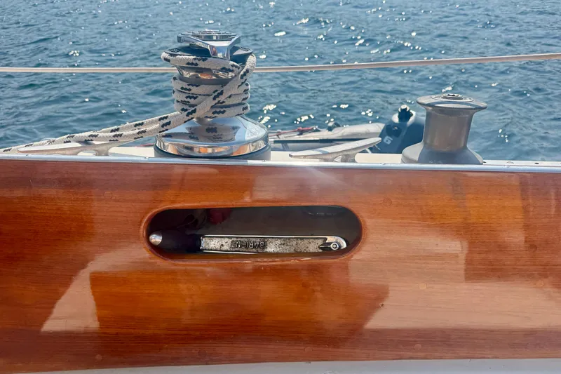 Slide: The Image of Polished wood deck of 1970 Hincley 38 sailboat with winch and rope. - 14