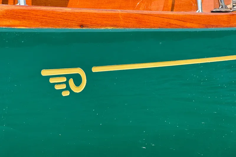 Slide: The Image of Green Hincley 38 boat hull with yellow emblem, wooden trim, 1970 model. - 10