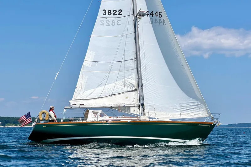 Slide: The Image of Sailboat on open water, 1970 Hincley 38, with American flag, clear blue sky. - 39