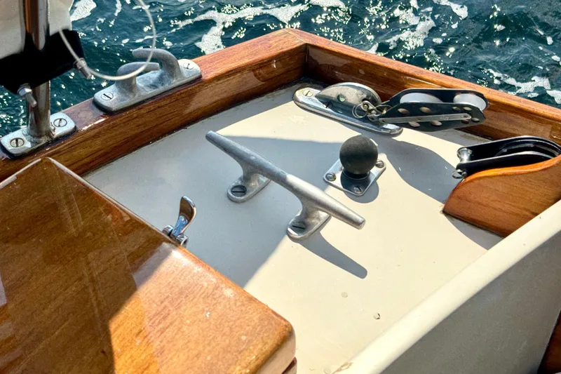 Slide: The Image of Cockpit of a 1970 Hincley 38 sailboat with nautical hardware and ocean view. - 13
