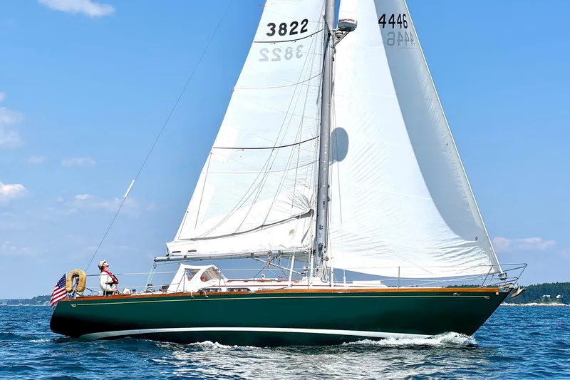 The Image of Vintage 1970 Hincley 38 sailboat cruising on open water under clear blue skies. - 0