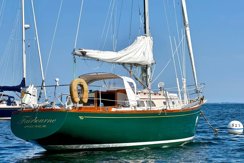 Slide: The Image of Vintage 1970 Hincley 38 sailboat anchored on calm blue waters. - 36