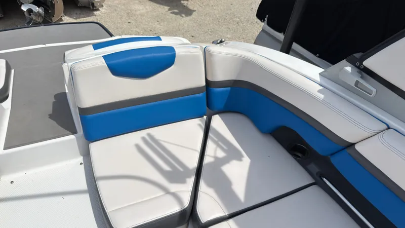 Slide: The Image of The 2017 Chaparral Vortex 223 VRX features white and blue cushioned seating. - 15