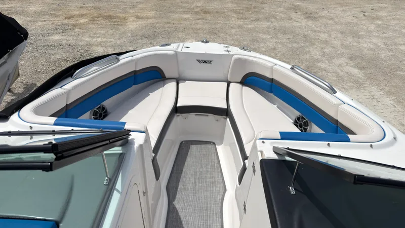 Slide: The Image of The image shows the bow area of a 2017 Chaparral Vortex 223 VRX with blue and white upholstery. - 30