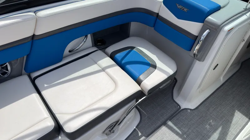 Slide: The Image of The image shows the interior of a 2017 Chaparral Vortex 223 VRX with blue and white seating. - 18