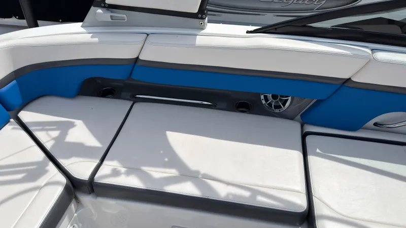 Slide: The Image of The image shows the seating area of a 2017 Chaparral Vortex 223 VRX with blue and gray upholstery. - 16