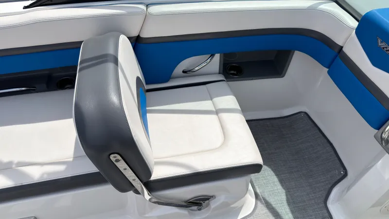 Slide: The Image of The image shows the interior of a 2017 Chaparral Vortex 223 VRX with blue and white seating. - 17