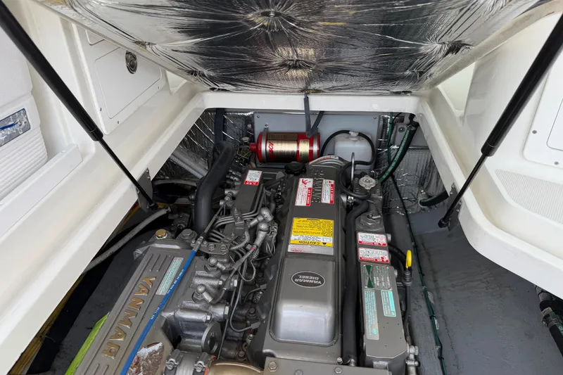 Slide: The Image of Engine compartment of a 2006 Back Cove 29 boat, featuring a Yanmar diesel engine. - 39
