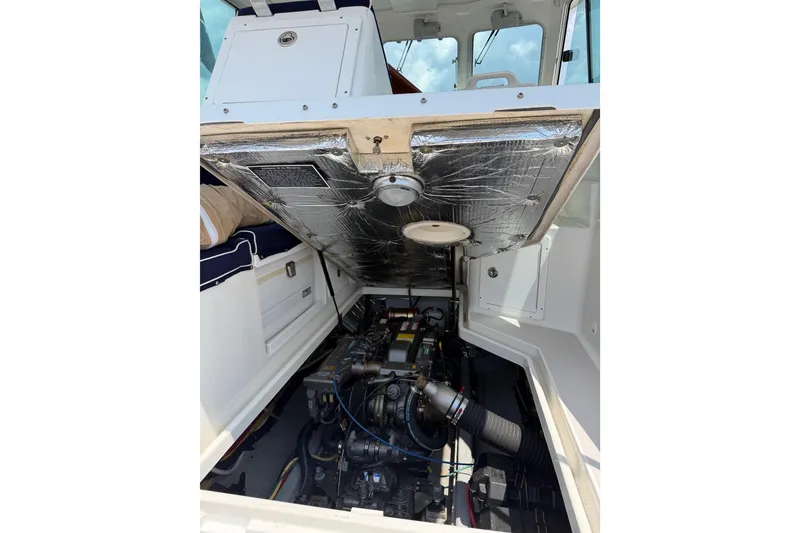 Slide: The Image of 2006 Back Cove 29 boat engine compartment with open hatch, showcasing engine details. - 43