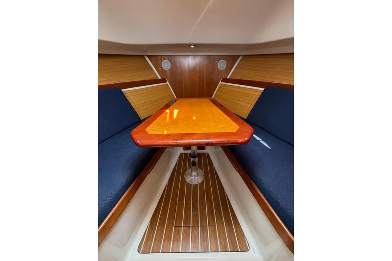 Slide: The Image of Interior of 2006 Back Cove 29 boat with wooden table and blue seating. - 25