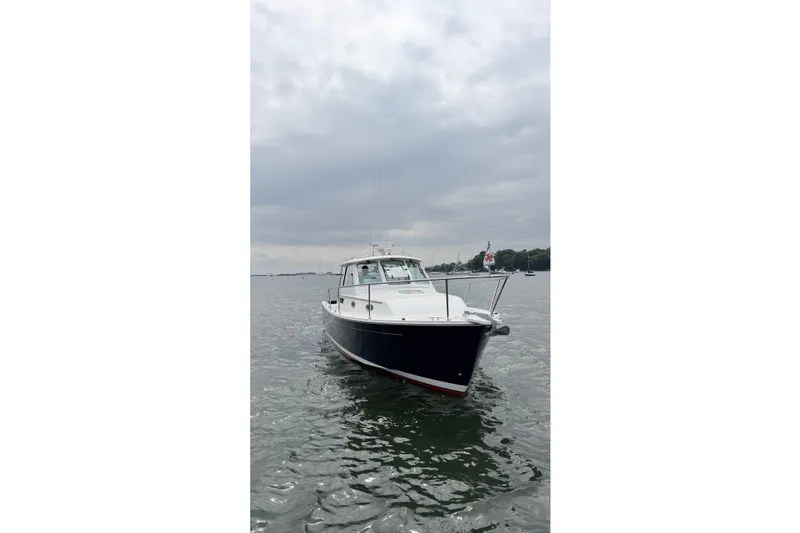 Slide: The Image of 2006 Back Cove 29 boat on calm water under cloudy sky. - 6