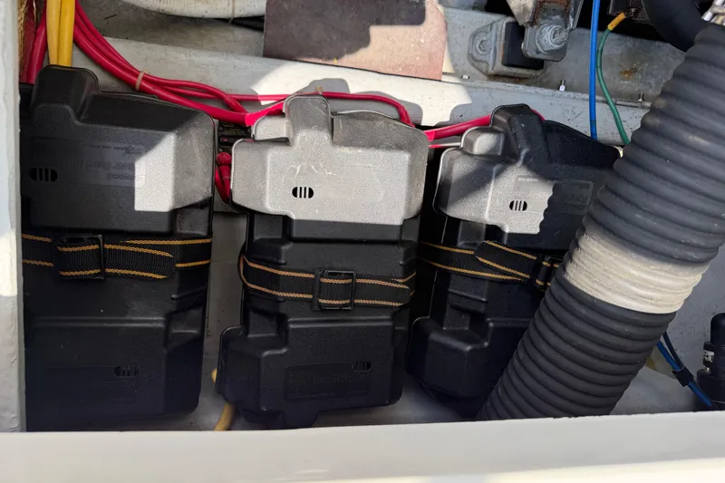 Slide: The Image of Battery compartment of a 2006 Back Cove 29 boat with secured black battery boxes. - 40