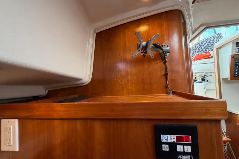 Slide: The Image of Interior of a 2006 Back Cove 29 boat with wooden paneling and a TV mount. - 31