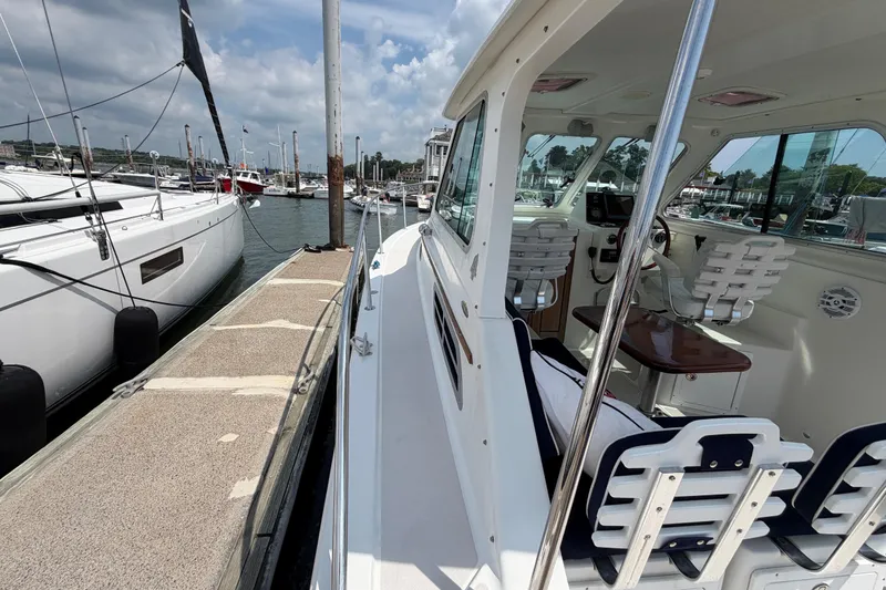 Slide: The Image of 2006 Back Cove 29 boat docked at marina, showcasing sleek design and spacious interior. - 44