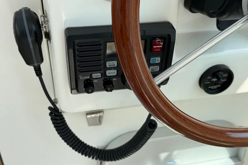 Slide: The Image of Steering wheel and radio controls on a 2006 Back Cove 29 boat. - 21