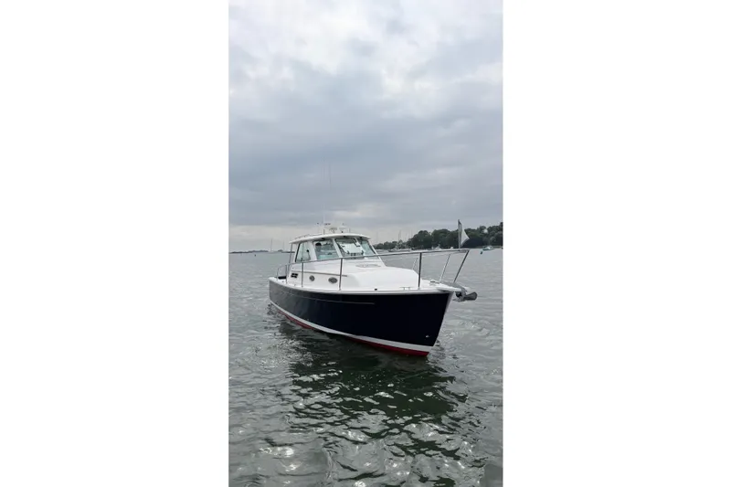 Slide: The Image of 2006 Back Cove 29 boat on calm water under cloudy sky. - 4