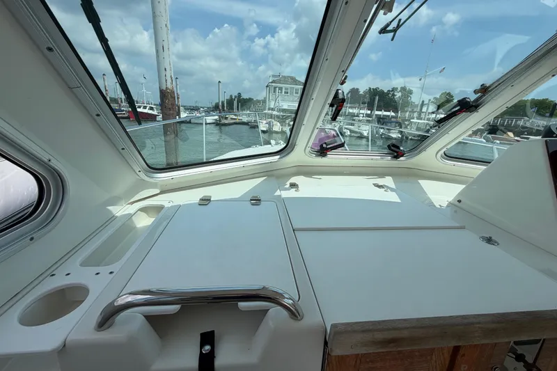 Slide: The Image of Interior view of 2006 Back Cove 29 boat with marina in background. - 19