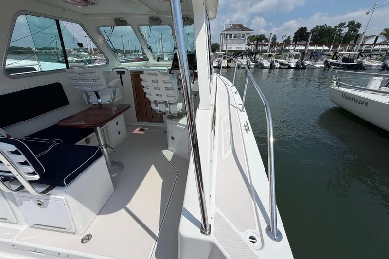 Slide: The Image of 2006 Back Cove 29 boat interior with seating and marina view. - 46