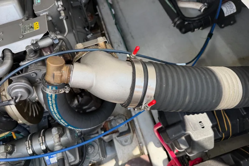 Slide: The Image of Engine compartment of a 2006 Back Cove 29 boat, featuring hoses and mechanical components. - 38